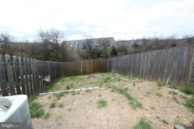 a backyard of a house with green landscape