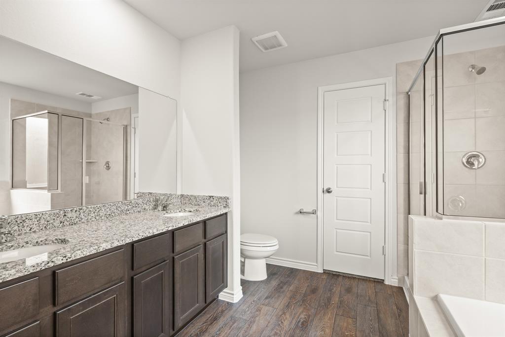 1507 Romans Road Ennis, TX 75119 - Photo 12 of 19 a bathroom with a granite countertop sink toilet and shower