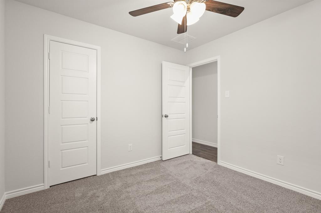 1507 Romans Road Ennis, TX 75119 - Photo 13 of 19 an empty room with a ceiling fan