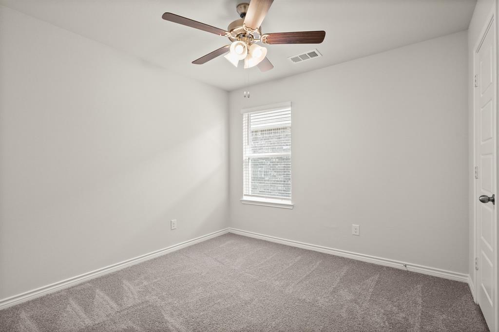 1507 Romans Road Ennis, TX 75119 - Photo 14 of 19 an empty room with a window and a fan