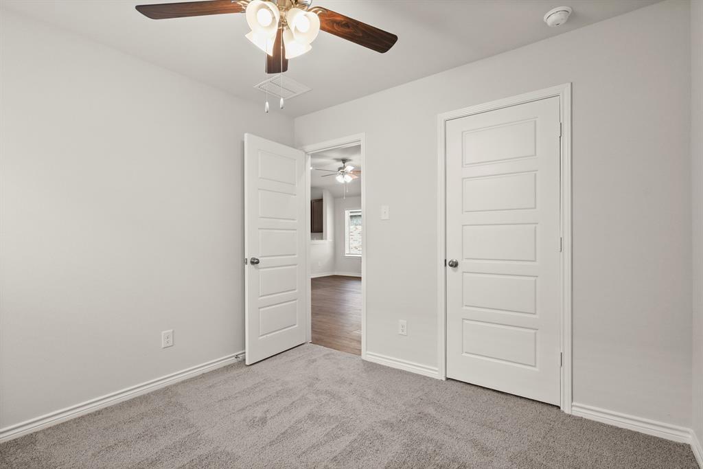 1507 Romans Road Ennis, TX 75119 - Photo 16 of 19 an empty room with a cabinet and a ceiling fan