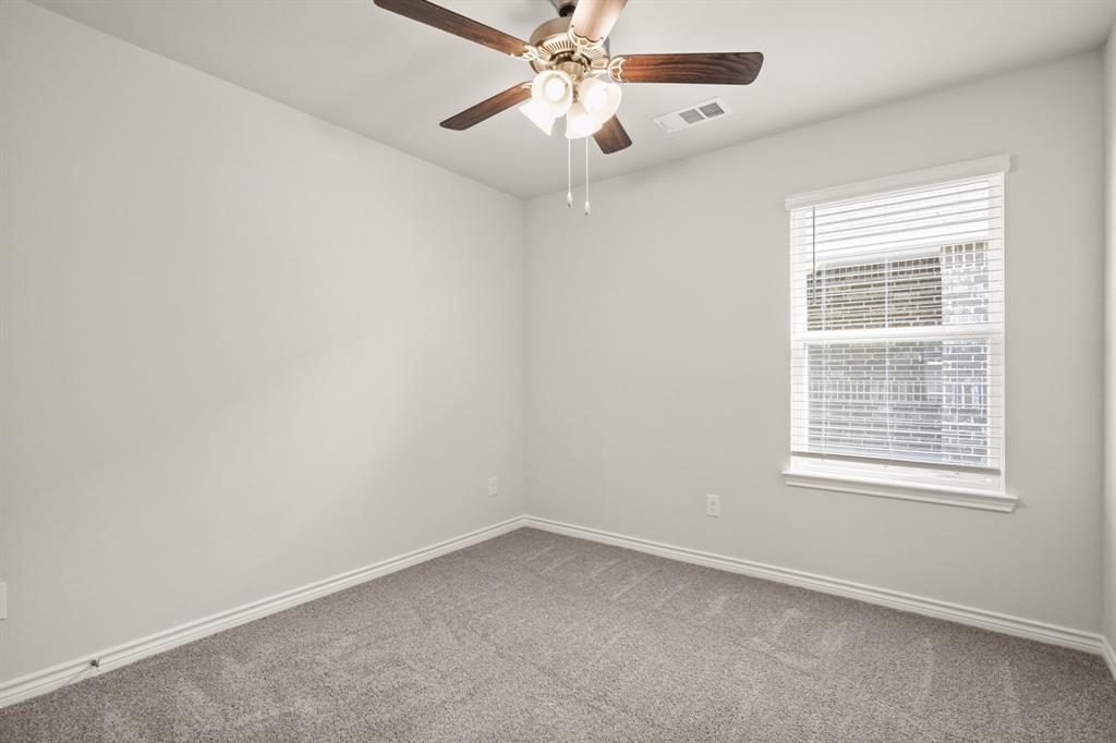 1507 Romans Road Ennis, TX 75119 - Photo 17 of 19 an empty room with a window and a fan