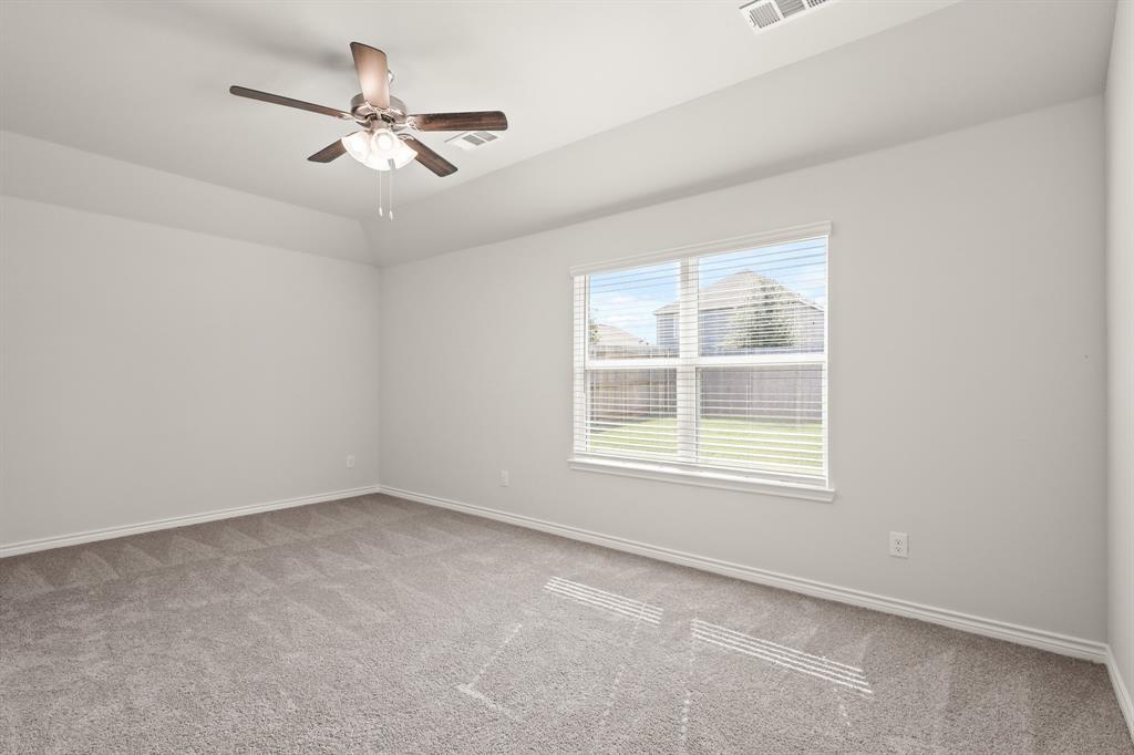 1507 Romans Road Ennis, TX 75119 - Photo 10 of 19 an empty room with a window and a fan
