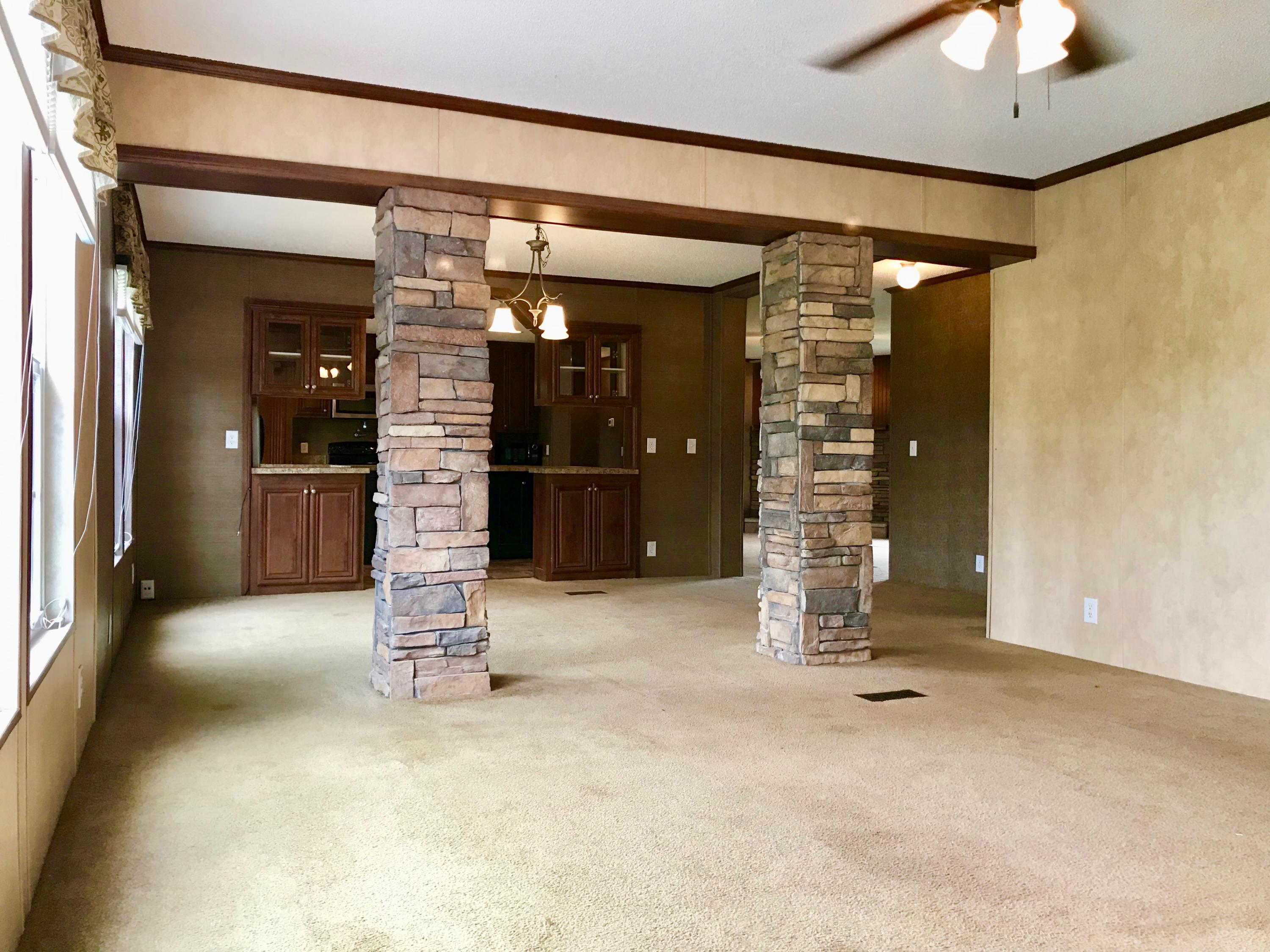 en empty room with fireplace and window