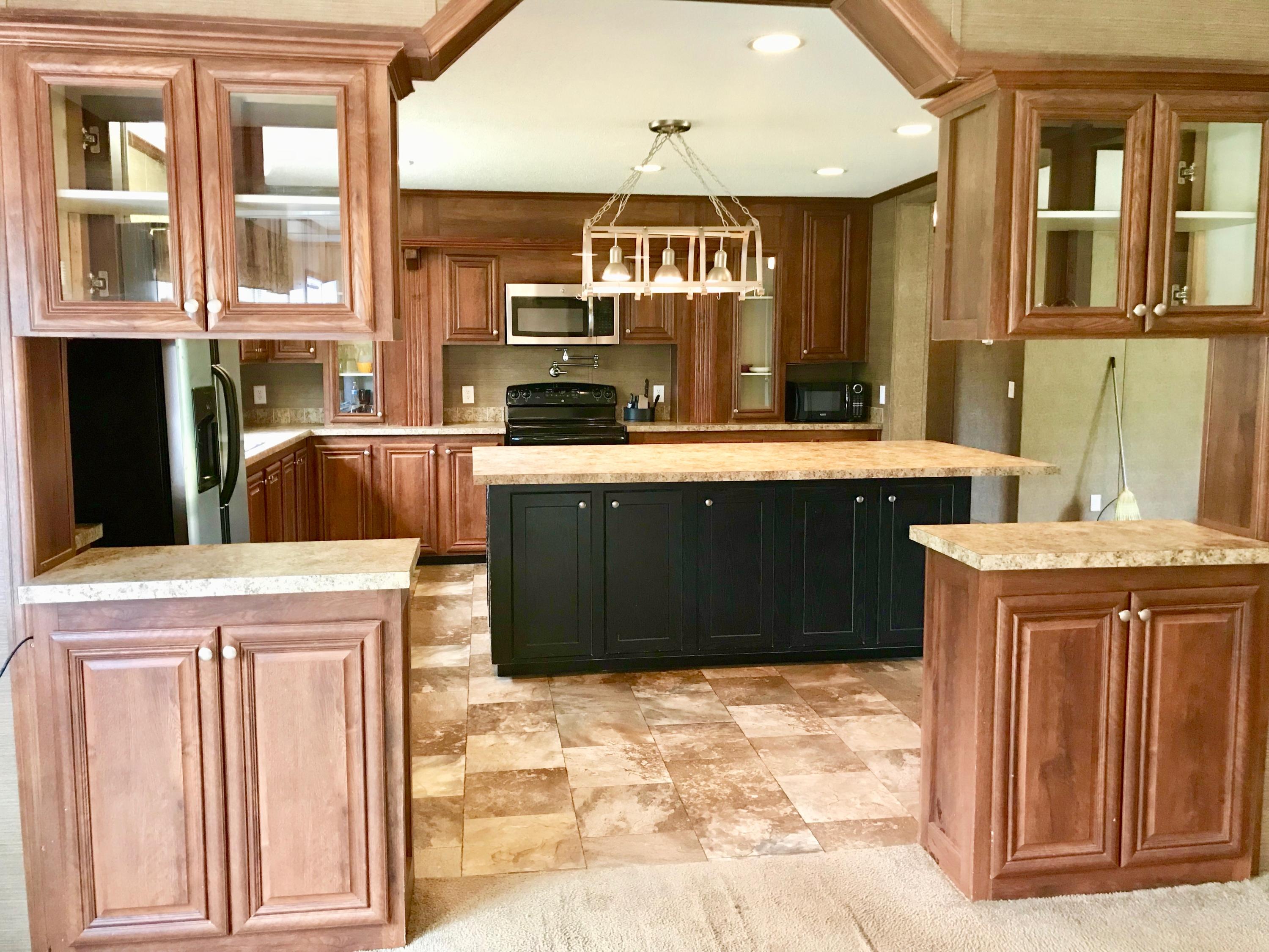 9840 American Farms Road Milton, FL 32583 - Photo 2 of 42 a kitchen with stainless steel appliances granite countertop a refrigerator and a stove top oven