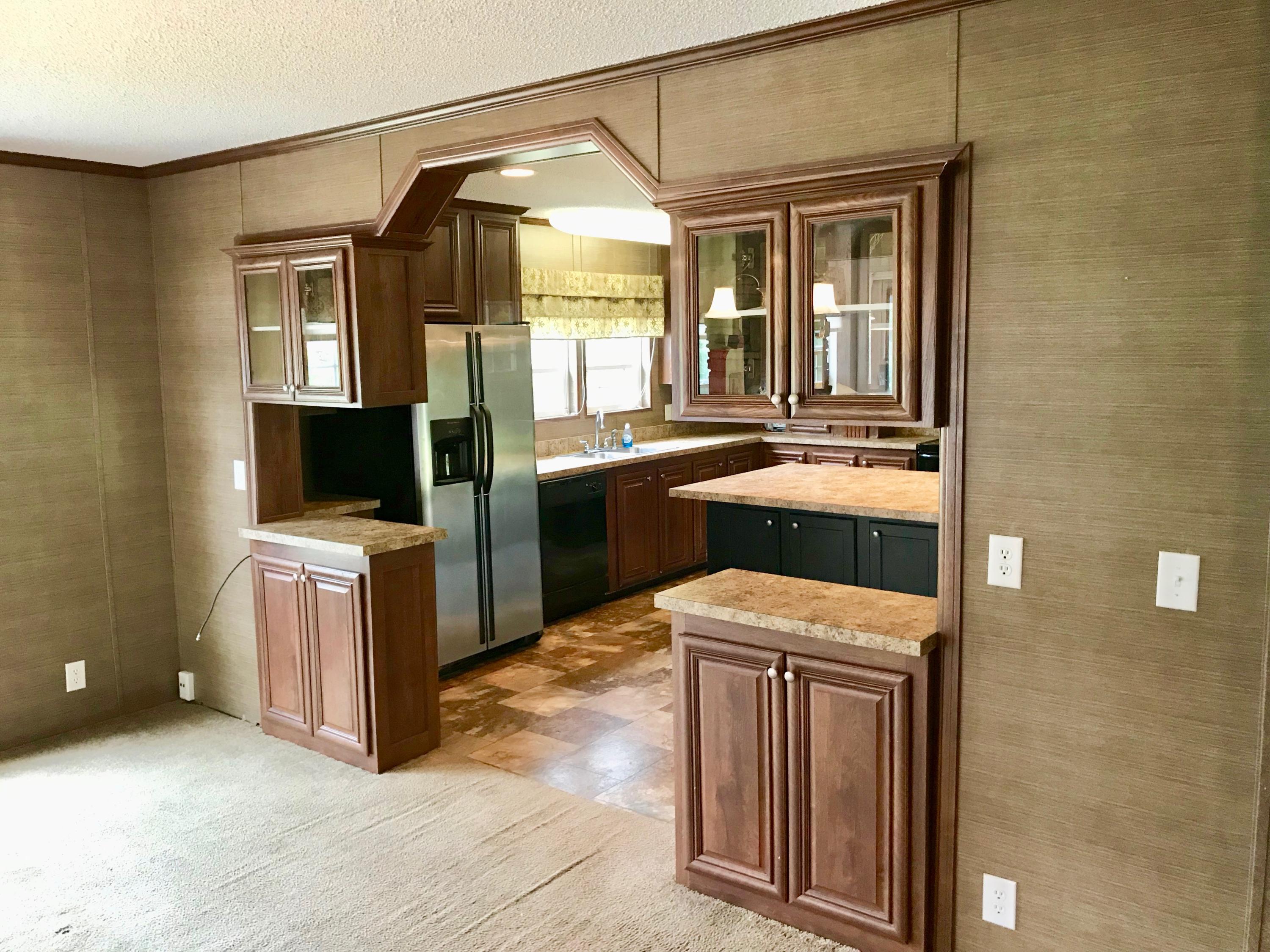 9840 American Farms Road Milton, FL 32583 - Photo 11 of 42 a kitchen with kitchen island a sink stove and refrigerator