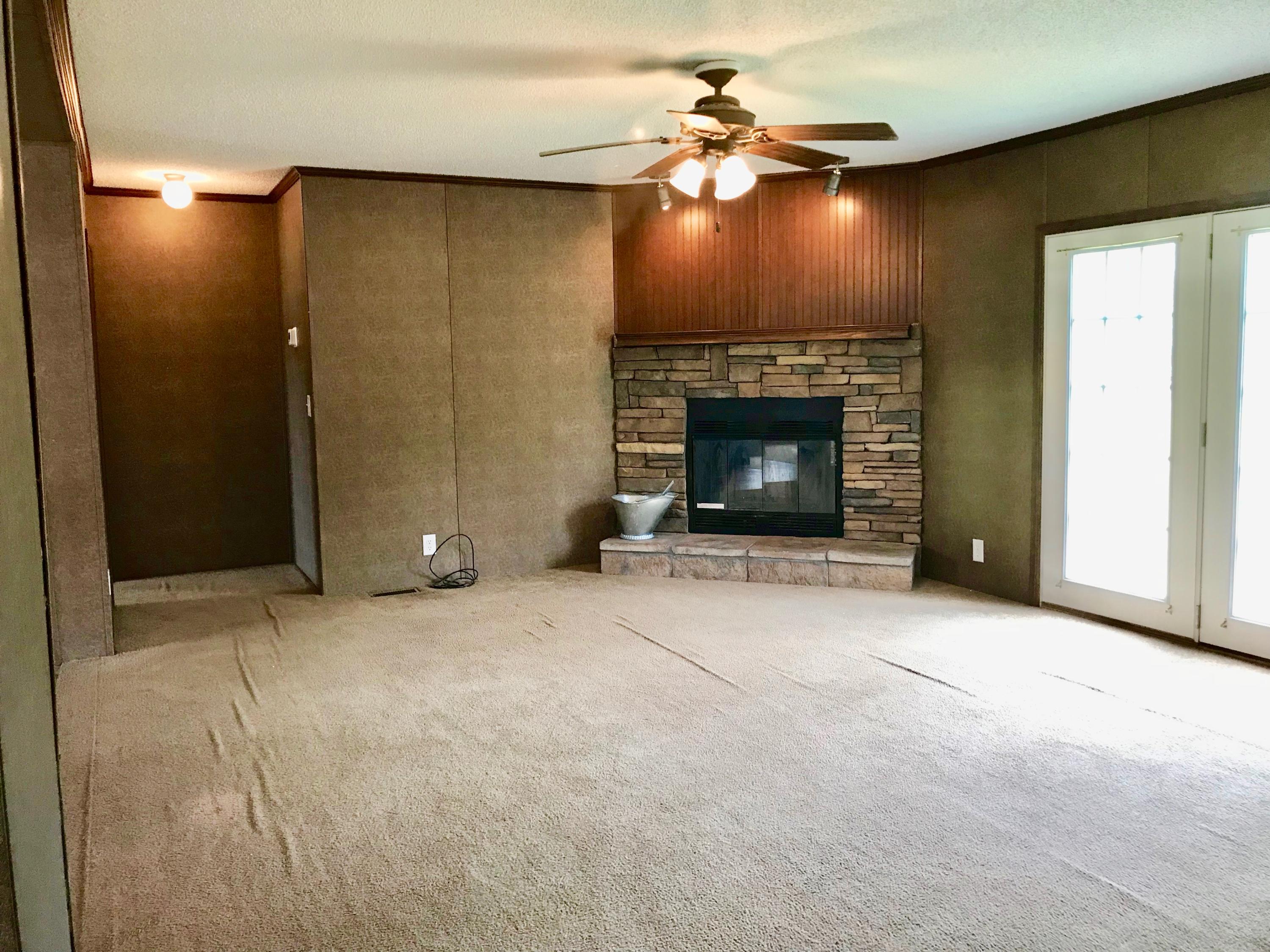 9840 American Farms Road Milton, FL 32583 - Photo 12 of 42 a view of an empty room with a fireplace
