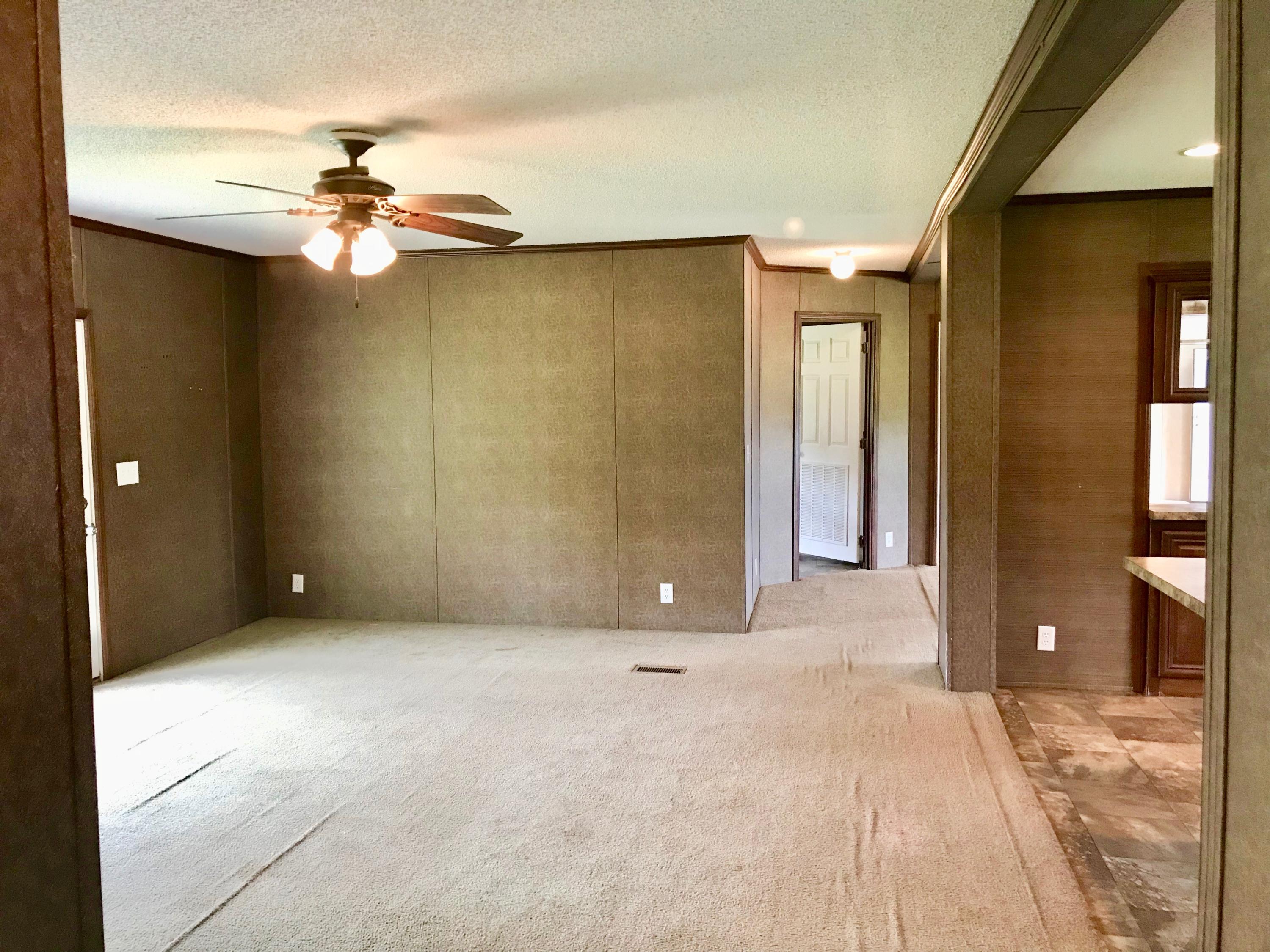 9840 American Farms Road Milton, FL 32583 - Photo 13 of 42 a view of an empty room with a chandelier fan
