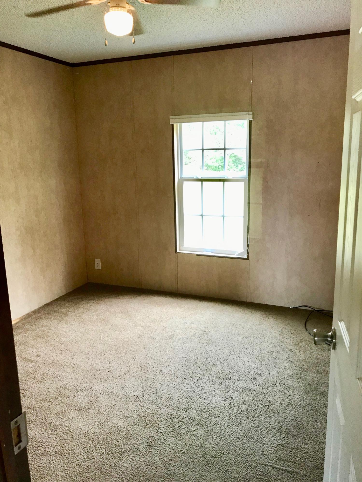 9840 American Farms Road Milton, FL 32583 - Photo 22 of 42 an empty room with a window