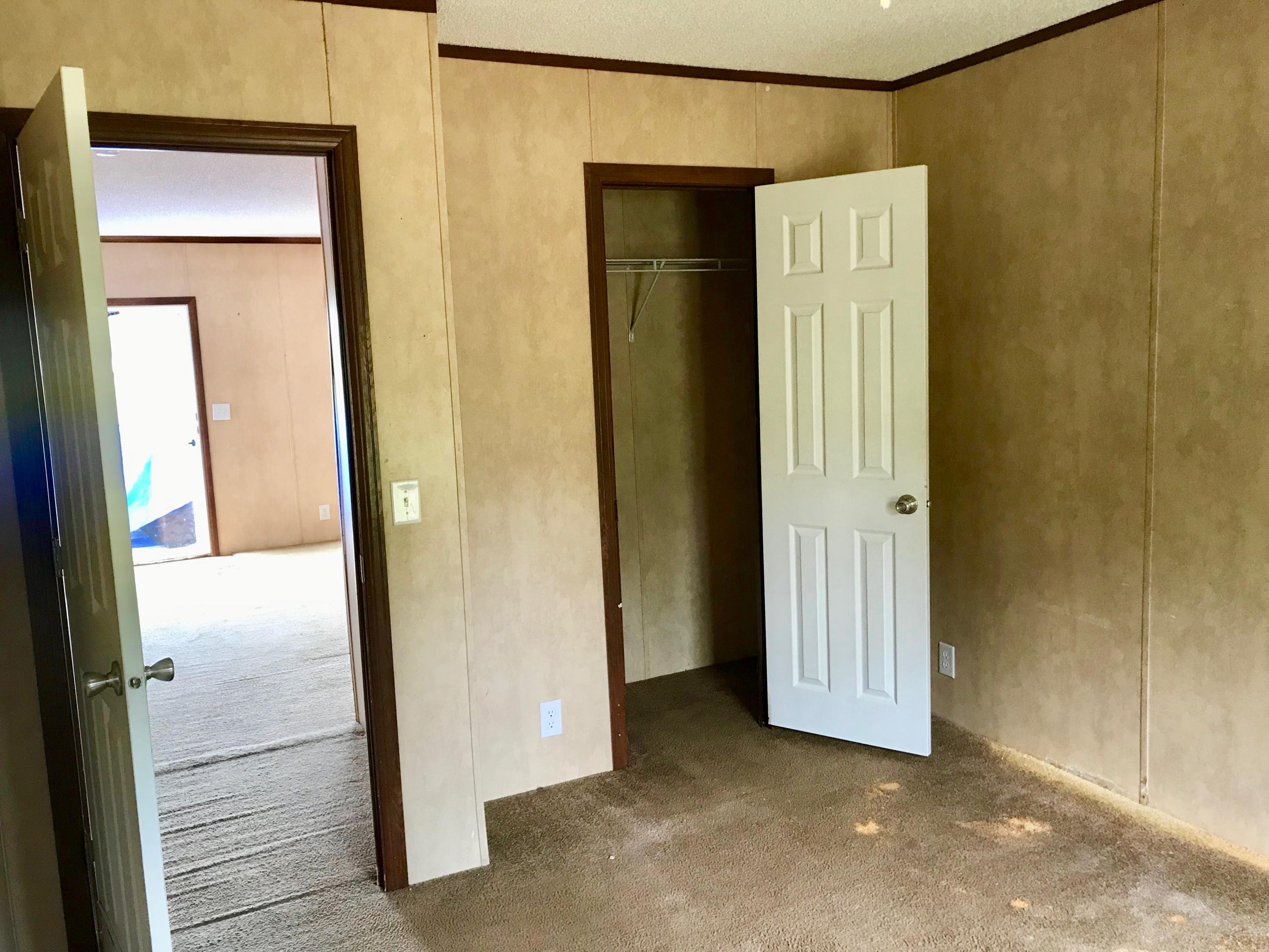 9840 American Farms Road Milton, FL 32583 - Photo 23 of 42 a view of a hallway with wooden floor
