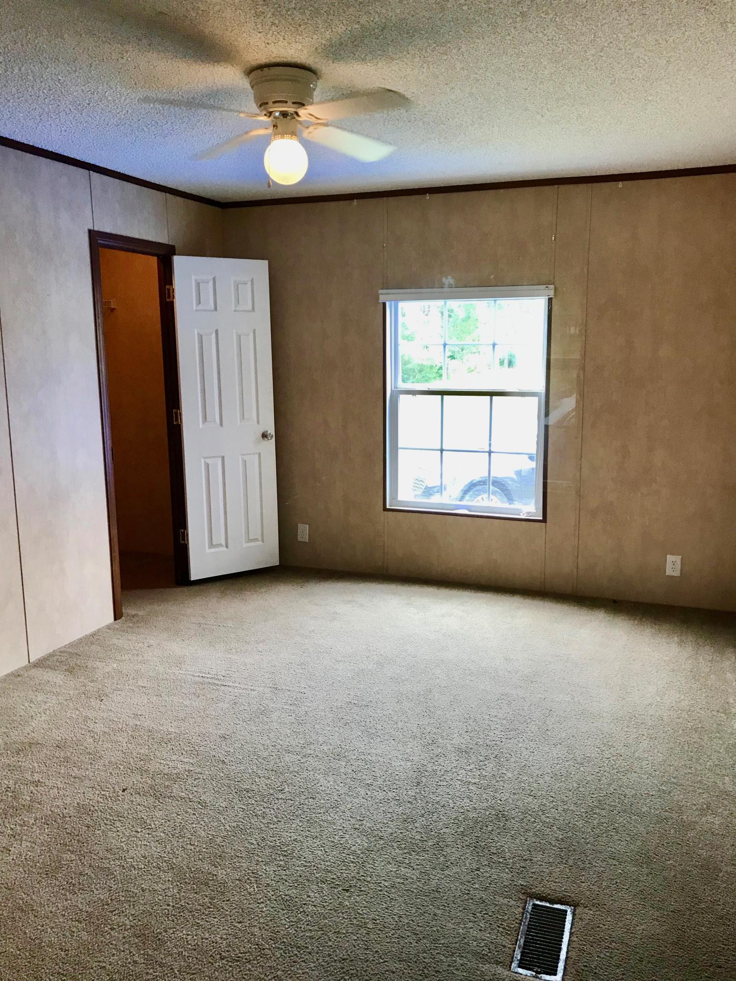 9840 American Farms Road Milton, FL 32583 - Photo 24 of 42 an empty room with windows and closet