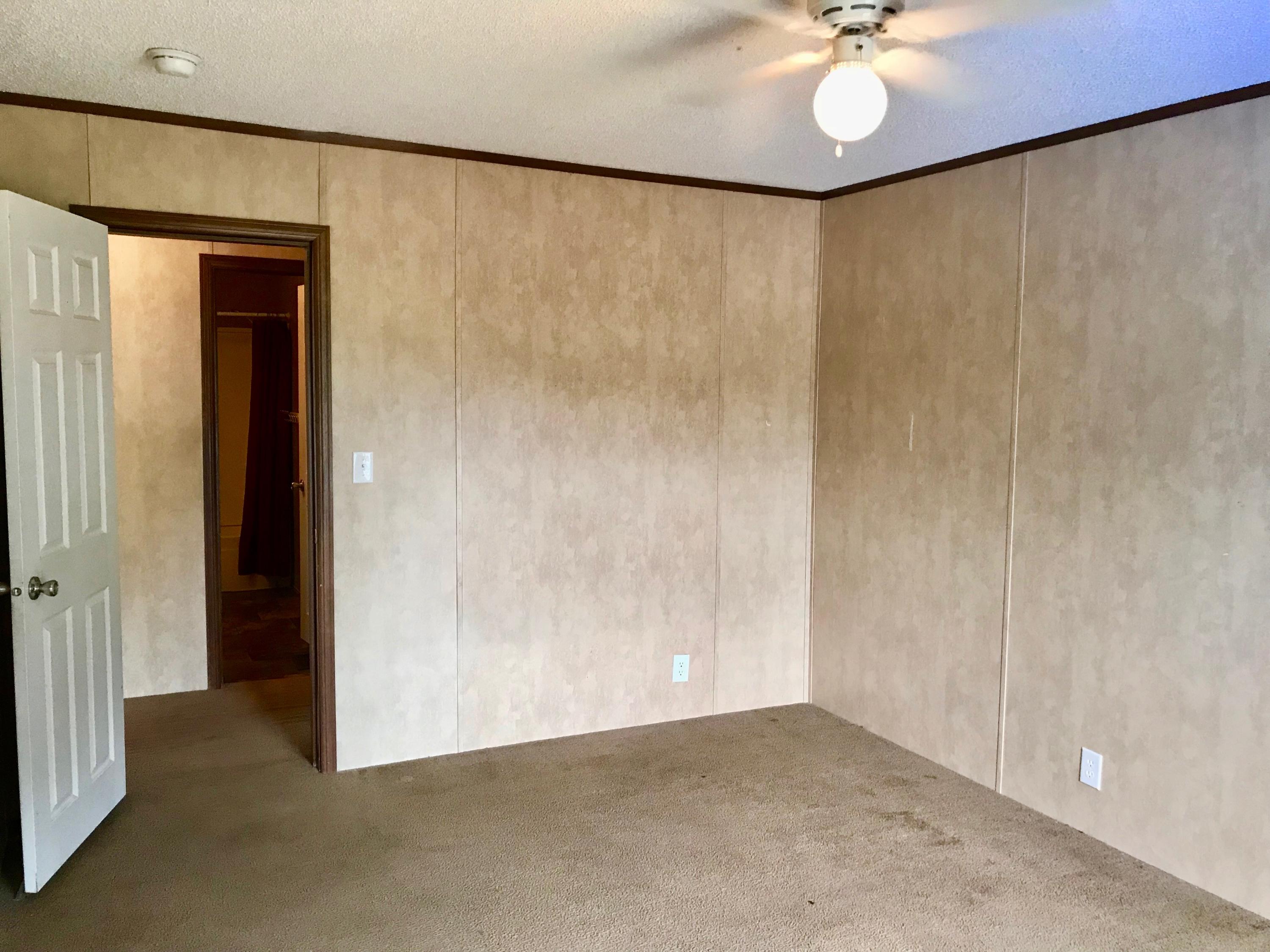 9840 American Farms Road Milton, FL 32583 - Photo 25 of 42 a view of an empty room with a chandelier fan