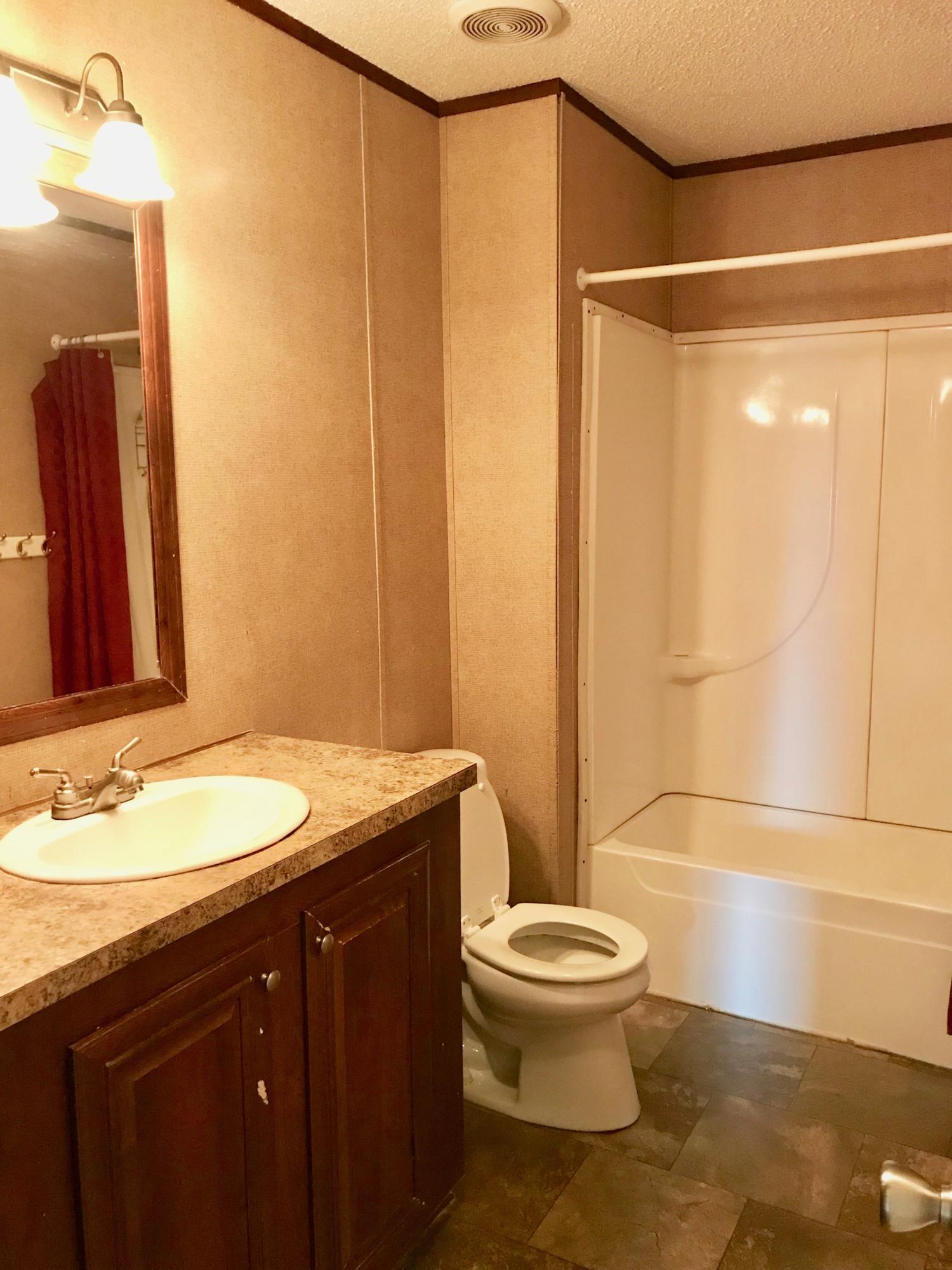 9840 American Farms Road Milton, FL 32583 - Photo 27 of 42 a bathroom with a sink and a mirror