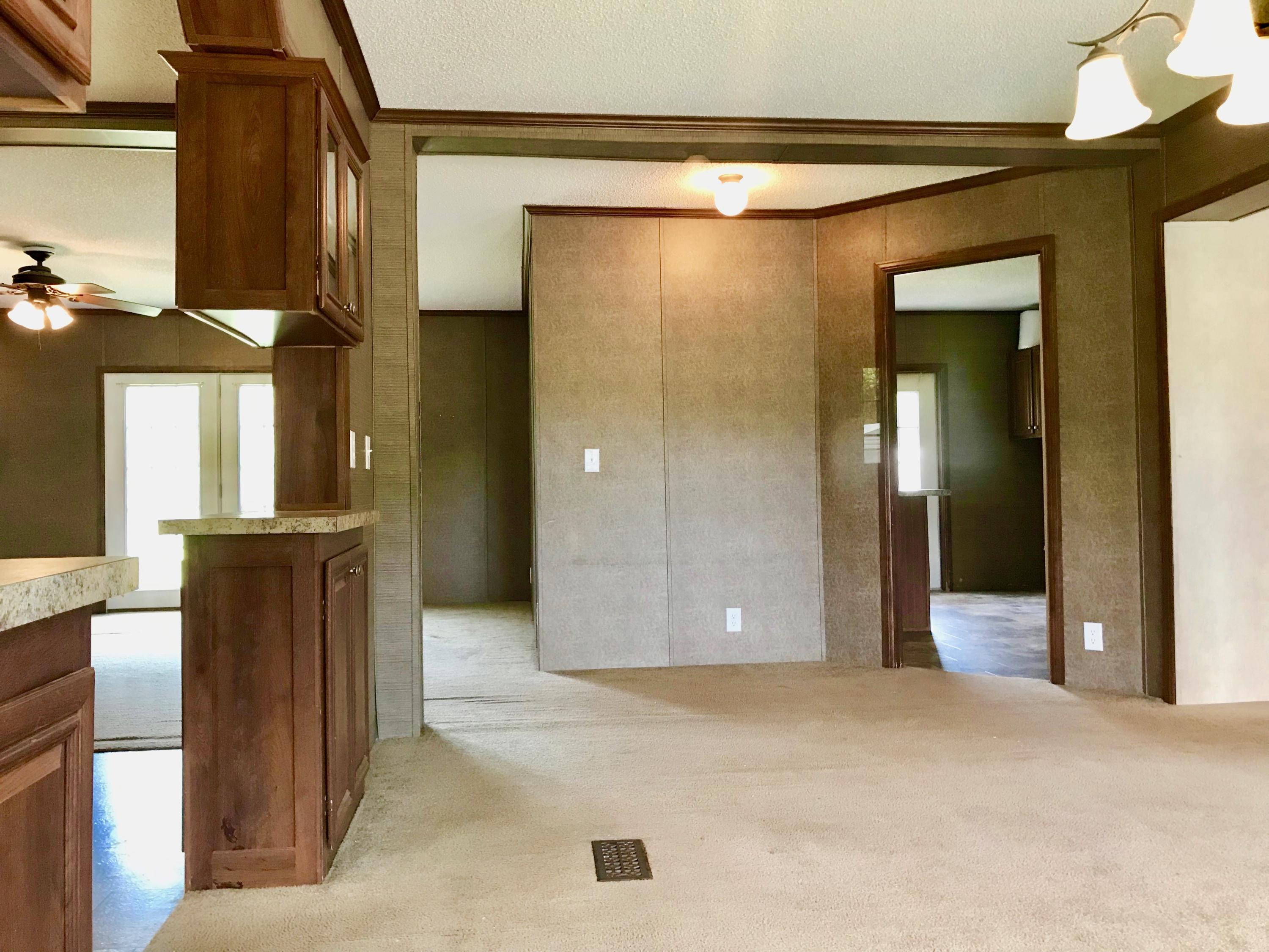 9840 American Farms Road Milton, FL 32583 - Photo 4 of 42 a view of a hallway with wooden floor