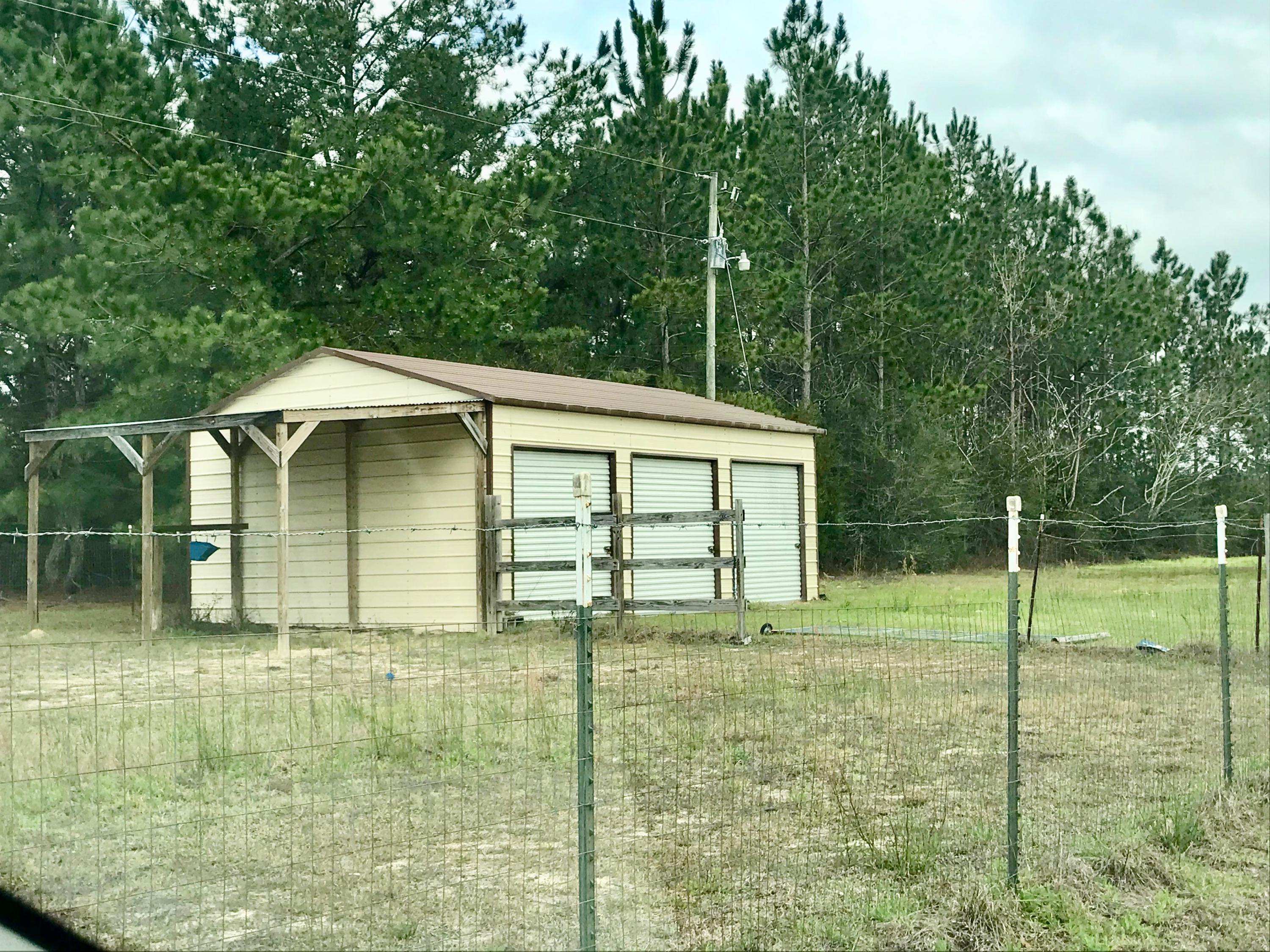 9840 American Farms Road Milton, FL 32583 - Photo 33 of 42 a house with trees in the background