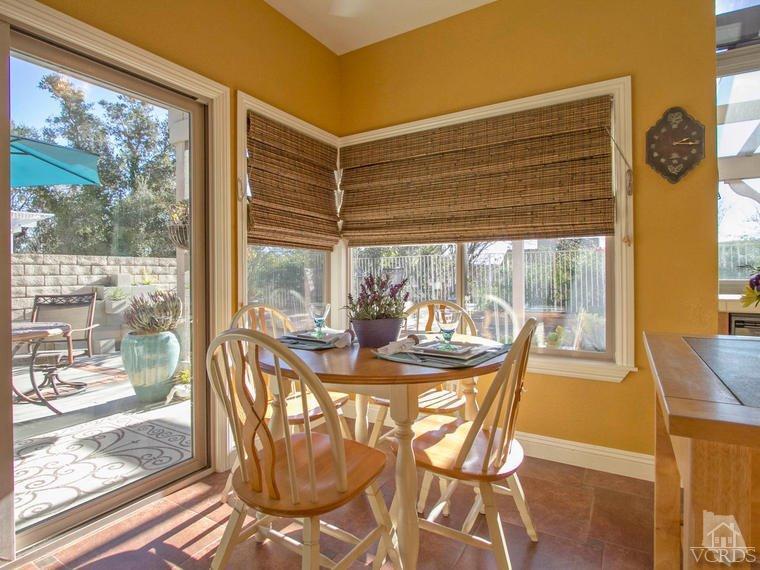 15310 Rains Court Moorpark, CA 93021 - Photo 14 of 29 a view of a dining room with furniture wooden floor and a floor to ceiling window