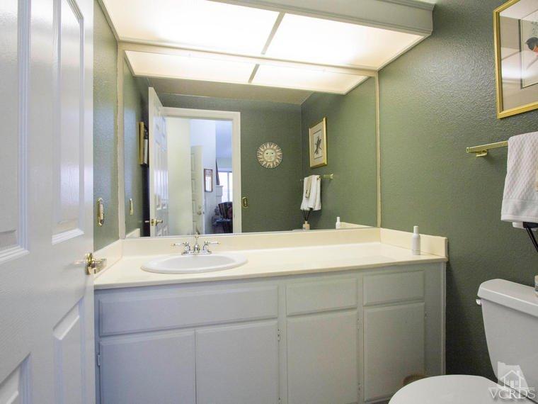 15310 Rains Court Moorpark, CA 93021 - Photo 15 of 29 a bathroom with a sink vanity granite toilet and a mirror