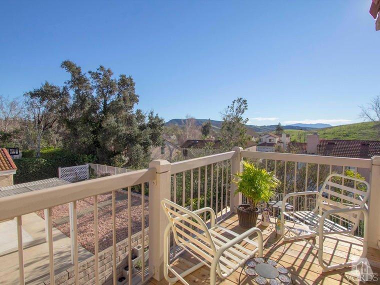 15310 Rains Court Moorpark, CA 93021 - Photo 19 of 29 a view of a balcony with wooden chairs and floor to ceiling window