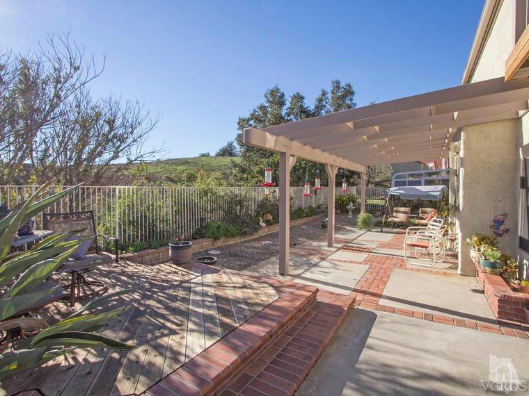 15310 Rains Court Moorpark, CA 93021 - Photo 27 of 29 a view of a patio with table and chairs and potted plants