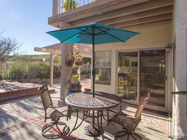 15310 Rains Court Moorpark, CA 93021 - Photo 29 of 29 a view of a patio with table and chairs under an umbrella