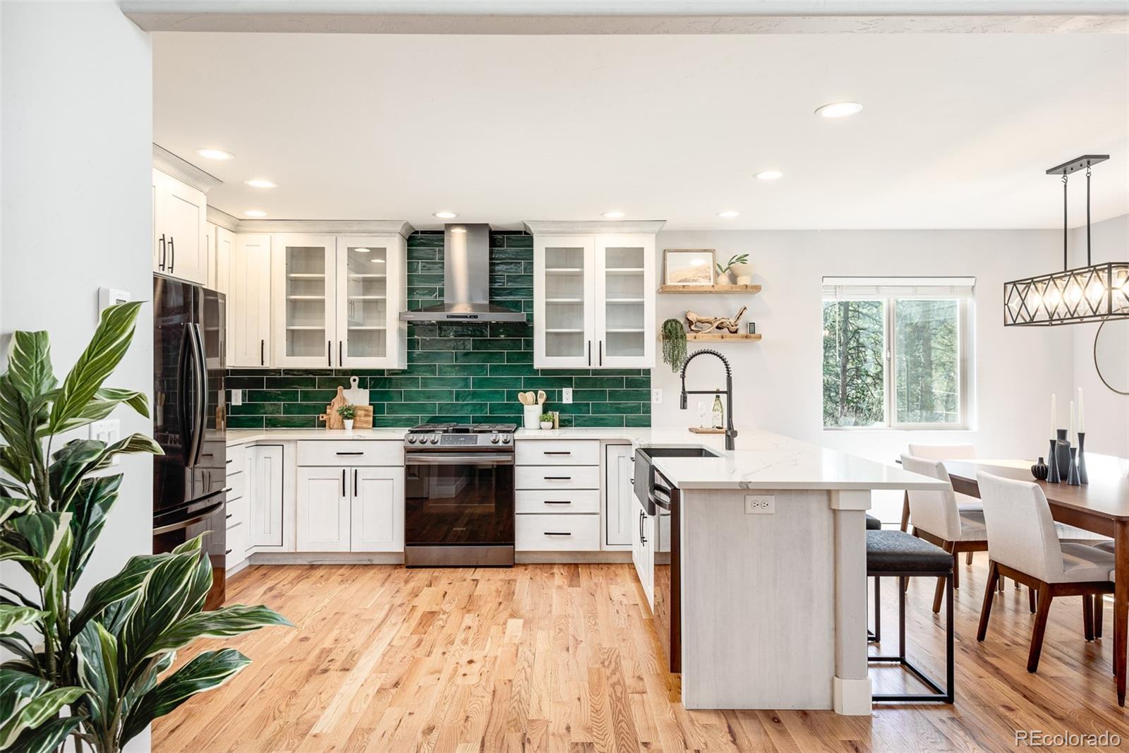 5132 Ute Road Indian Hills, CO 80454 - Photo 12 of 38 a large kitchen with kitchen island a stove a sink a counter space and cabinets