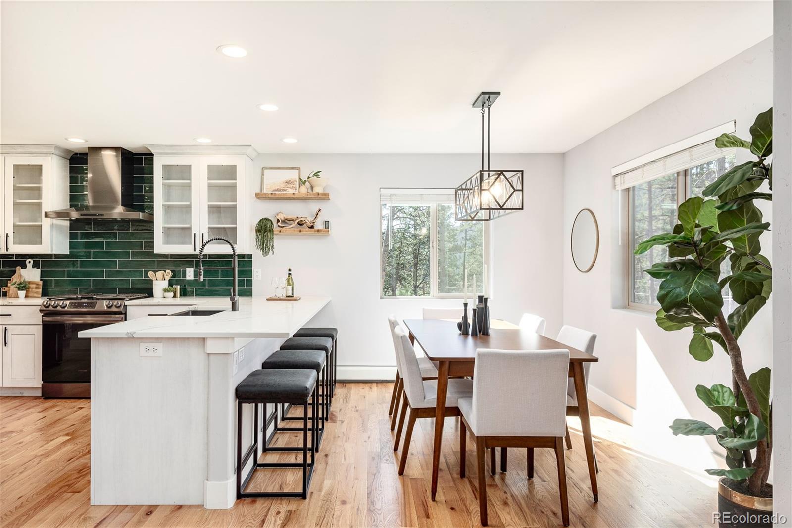 5132 Ute Road Indian Hills, CO 80454 - Photo 14 of 38 a dining room with furniture a chandelier and wooden floor