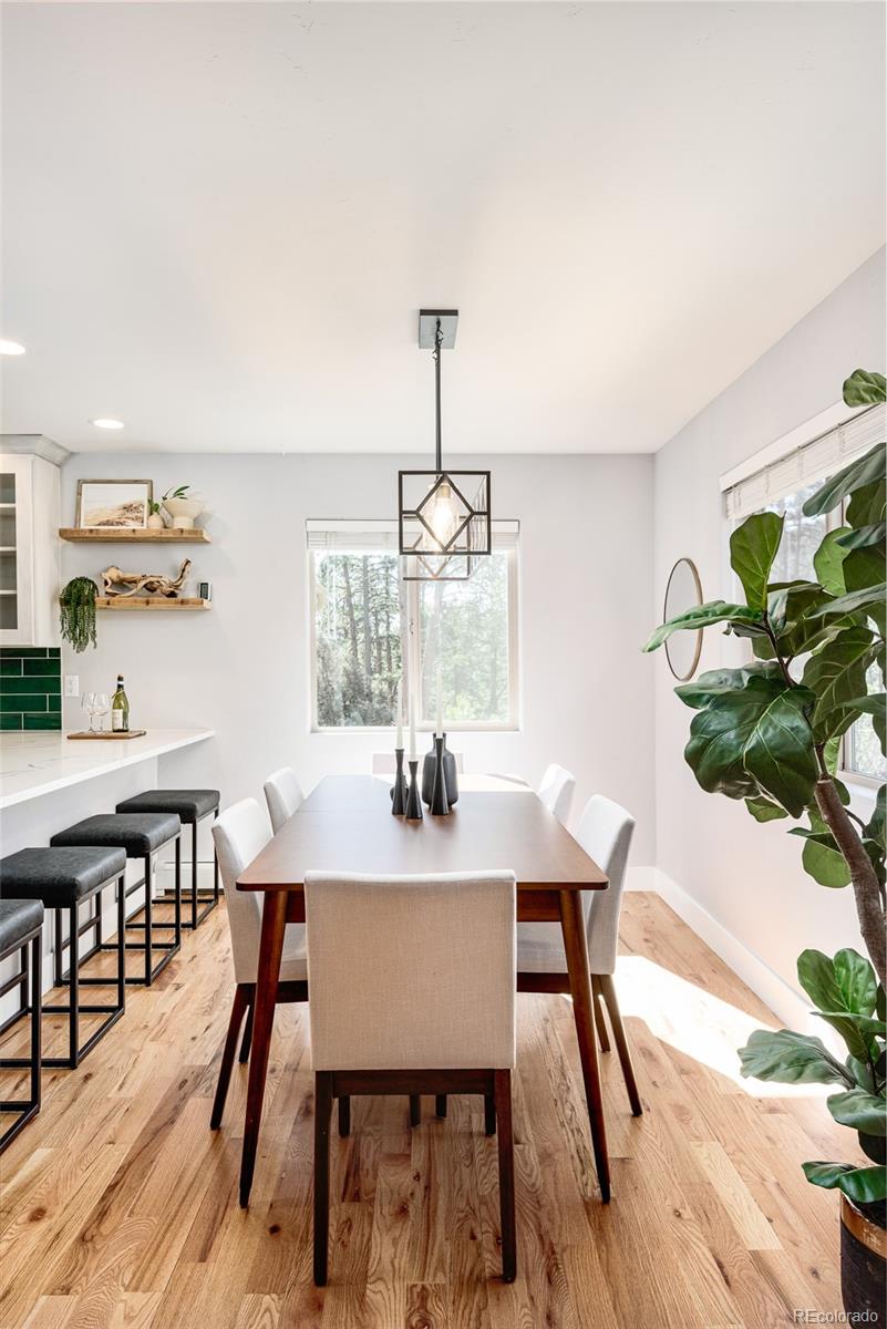 5132 Ute Road Indian Hills, CO 80454 - Photo 15 of 38 a view of a dining room with furniture window and wooden floor
