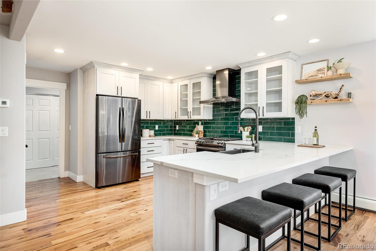 5132 Ute Road Indian Hills, CO 80454 - Photo 16 of 38 a kitchen with kitchen island a refrigerator stove and sink