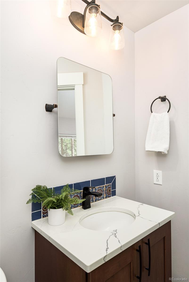 5132 Ute Road Indian Hills, CO 80454 - Photo 20 of 38 a bathroom with a sink and a mirror