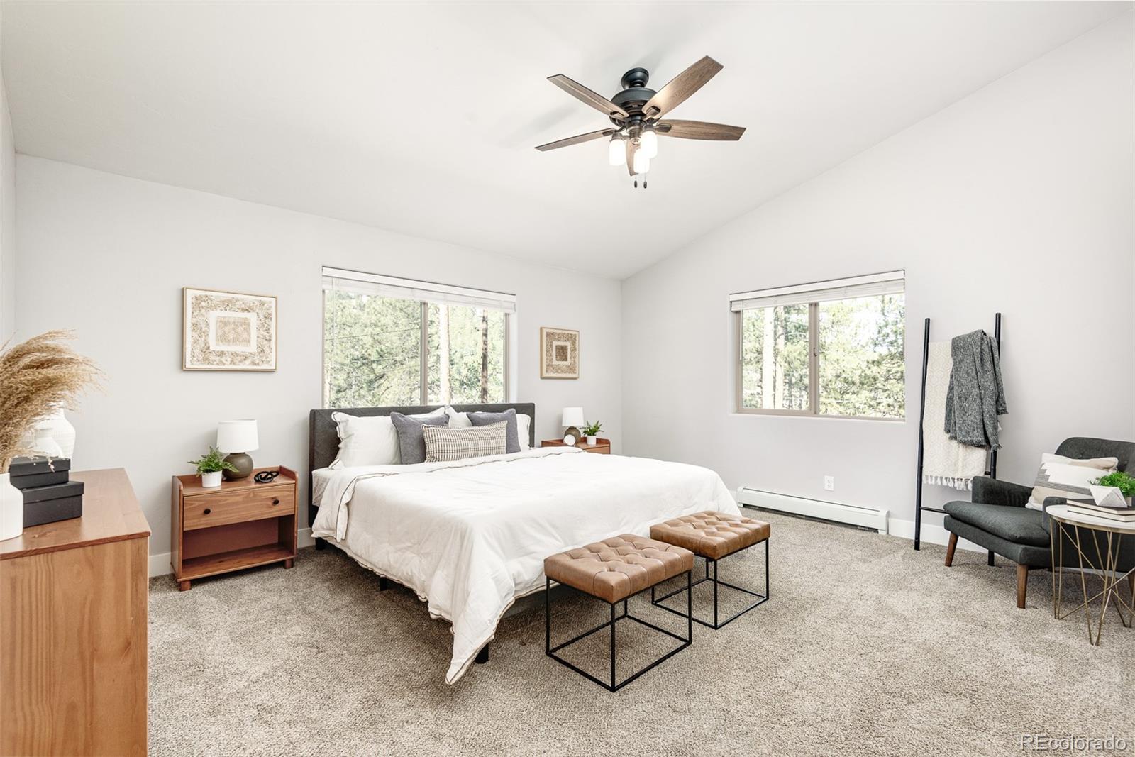 5132 Ute Road Indian Hills, CO 80454 - Photo 21 of 38 a bed room with a bed and a chandelier