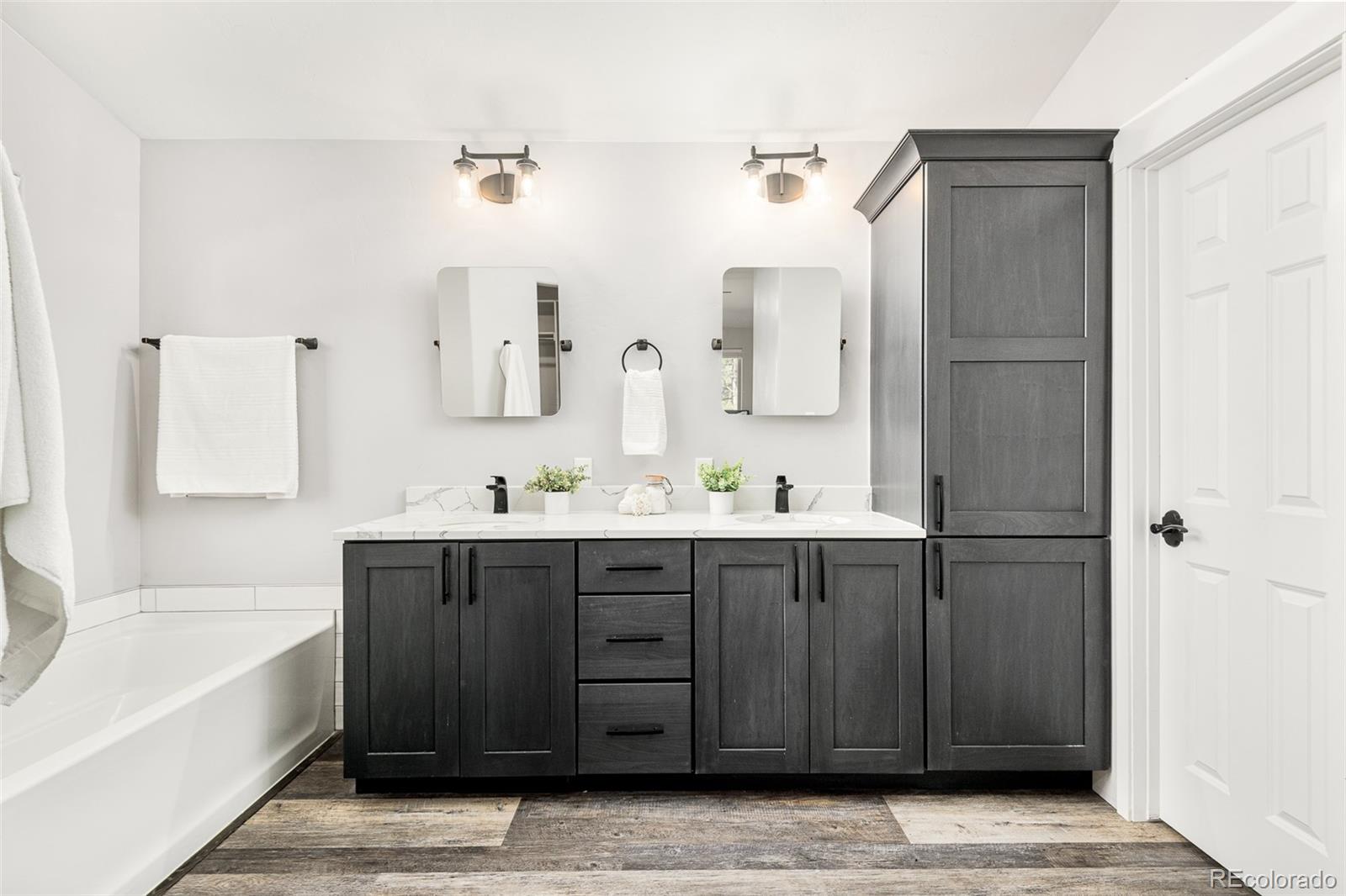 5132 Ute Road Indian Hills, CO 80454 - Photo 24 of 38 a bathroom with a tub sink and mirror