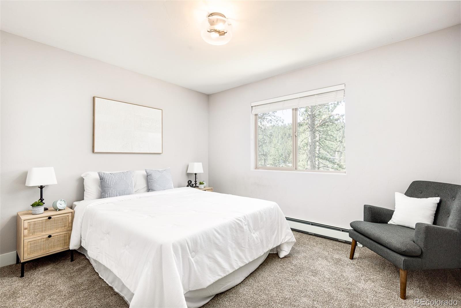 5132 Ute Road Indian Hills, CO 80454 - Photo 28 of 38 a bedroom with a bed and a couch