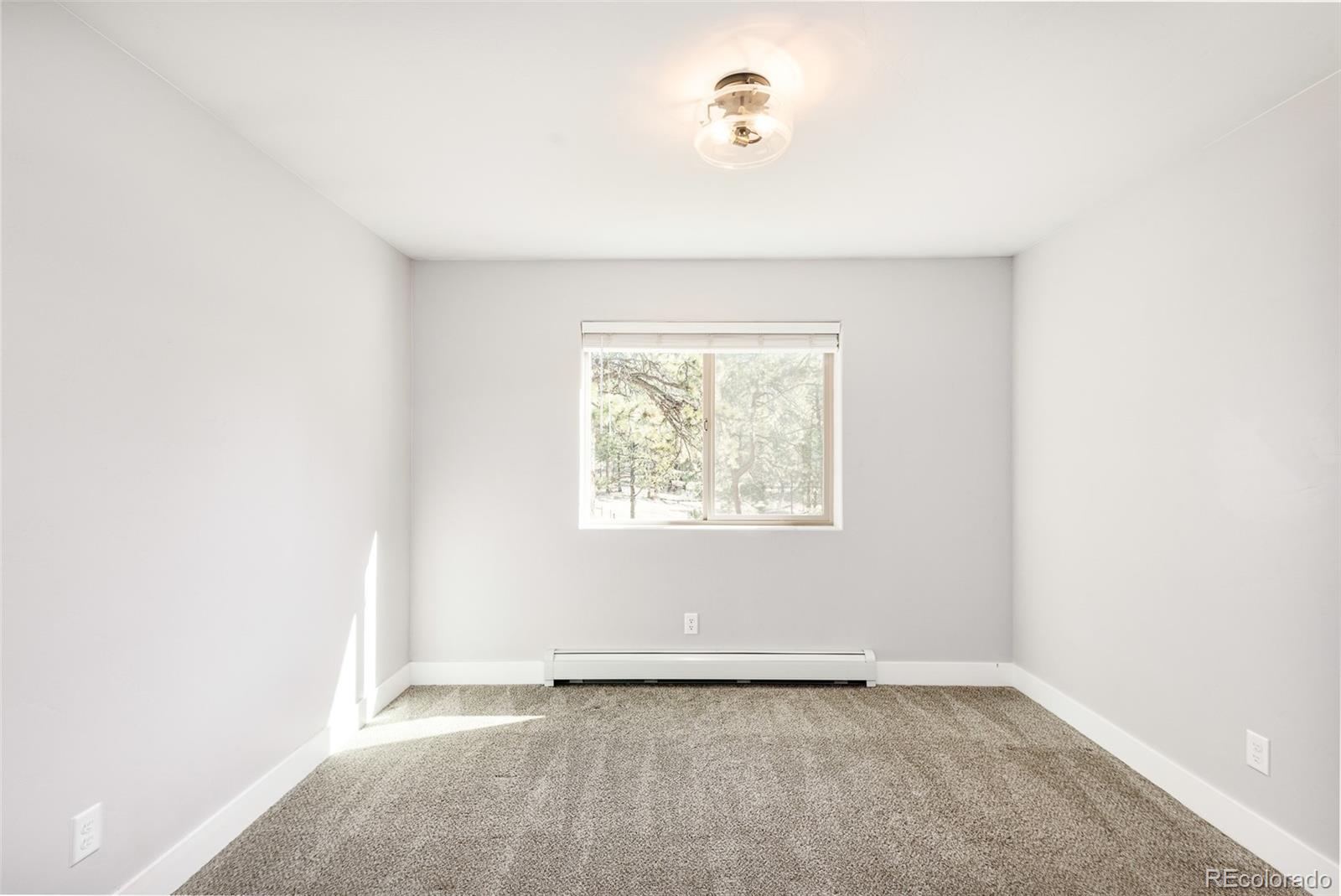 5132 Ute Road Indian Hills, CO 80454 - Photo 30 of 38 an empty room with a window