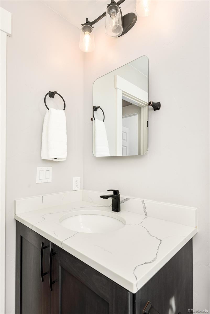 5132 Ute Road Indian Hills, CO 80454 - Photo 31 of 38 a bathroom with a sink and a mirror