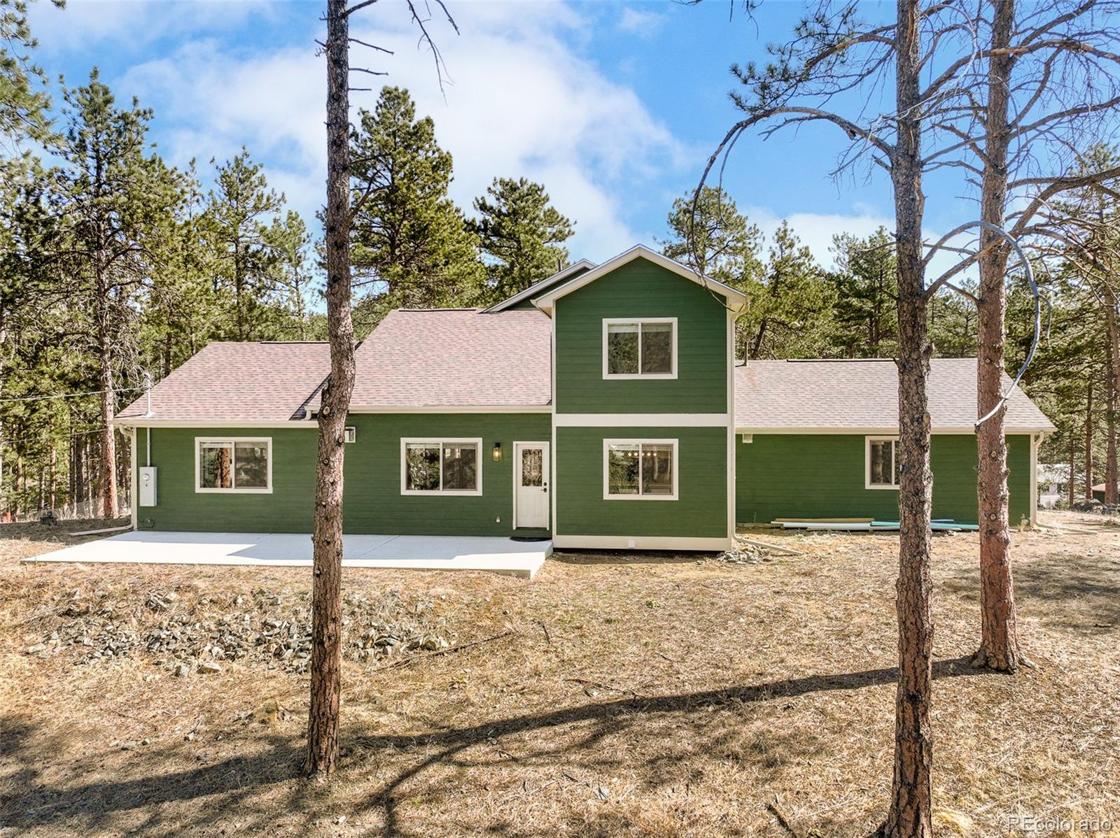 5132 Ute Road Indian Hills, CO 80454 - Photo 35 of 38 front view of a house with a yard