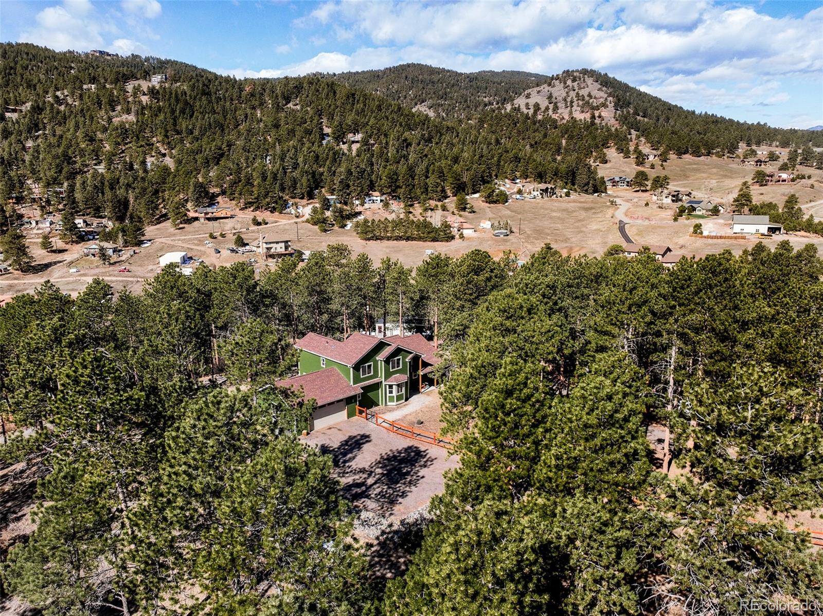 5132 Ute Road Indian Hills, CO 80454 - Photo 36 of 38 a view of a houses with a yard