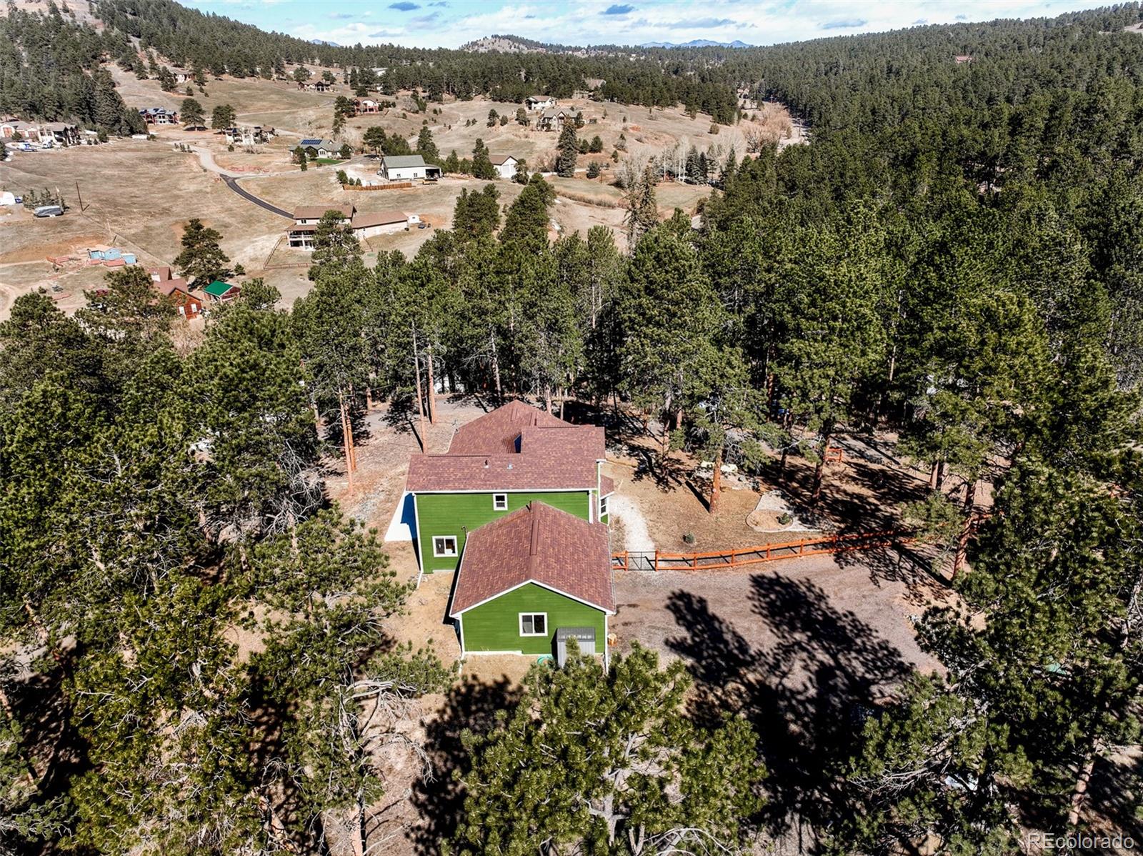 5132 Ute Road Indian Hills, CO 80454 - Photo 37 of 38 an aerial view of a house with a yard and lake view