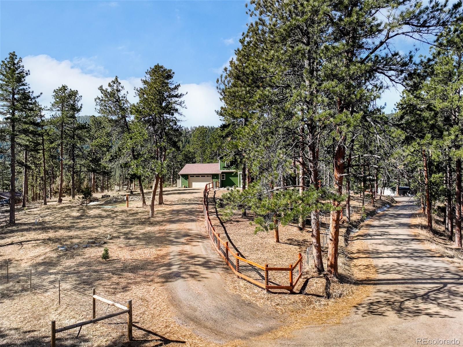 5132 Ute Road Indian Hills, CO 80454 - Photo 38 of 38 a view of a backyard with a bench