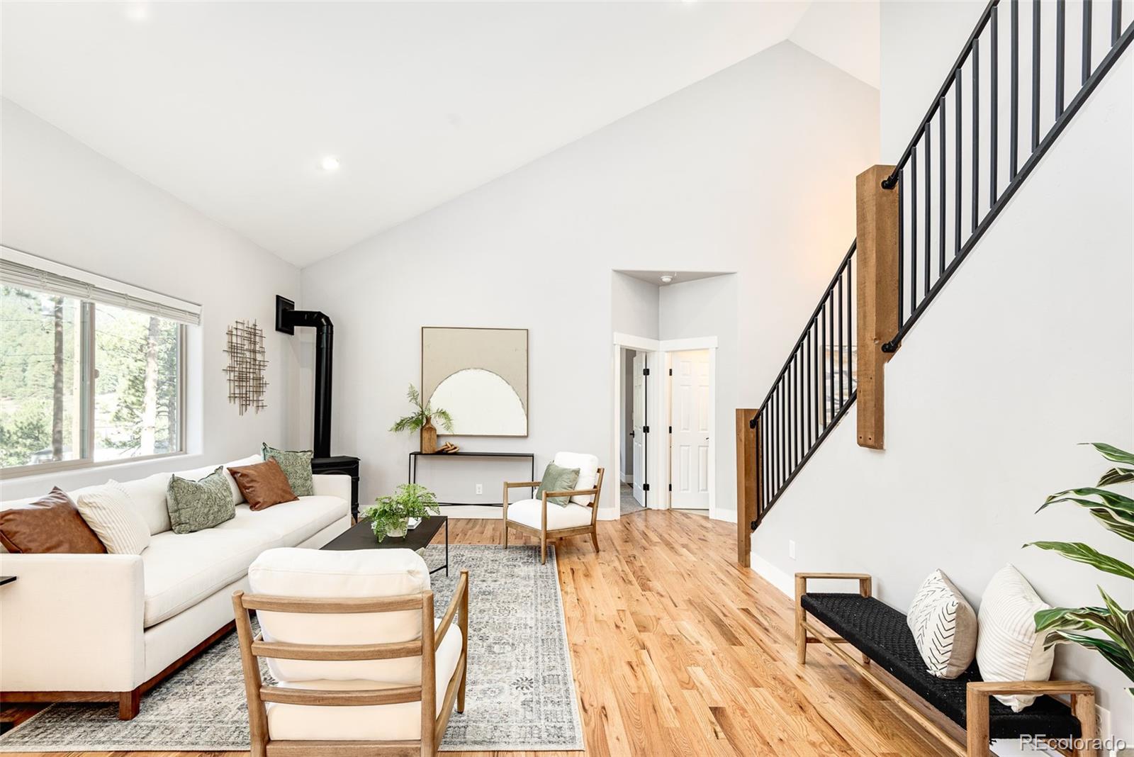 5132 Ute Road Indian Hills, CO 80454 - Photo 10 of 38 a living room with furniture and a table