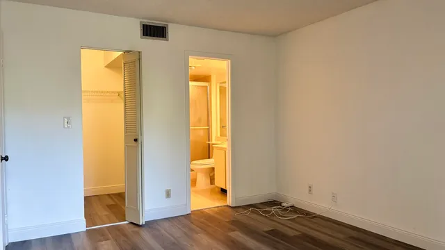 an empty room with wooden floor and a window