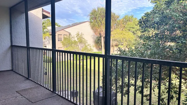 a view of a balcony with wooden floor