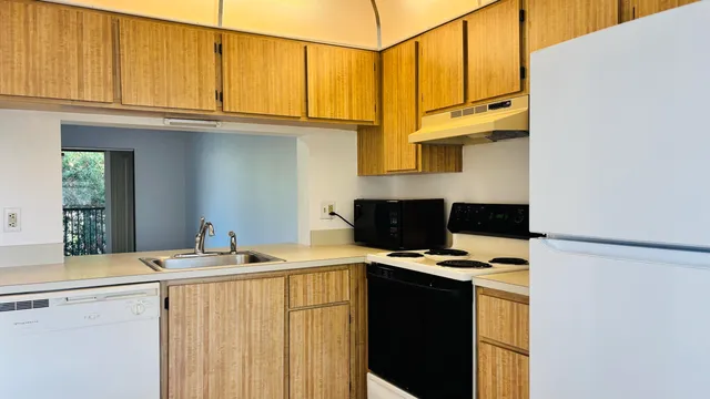 a kitchen with stainless steel appliances granite countertop a sink and a cabinets