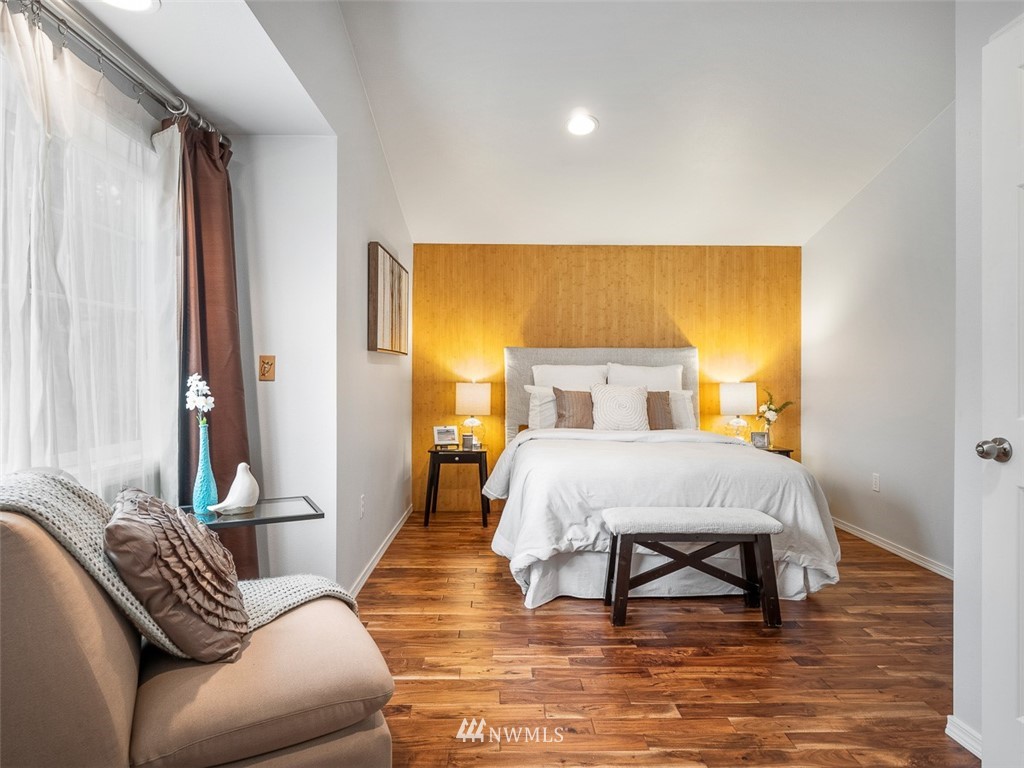 1212 North 85th Street, Unit B Seattle, WA 98103 - Photo 13 of 28 a bedroom with a bed and wooden floor