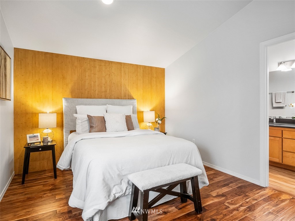 1212 North 85th Street, Unit B Seattle, WA 98103 - Photo 14 of 28 a bedroom with a bed and wooden floor