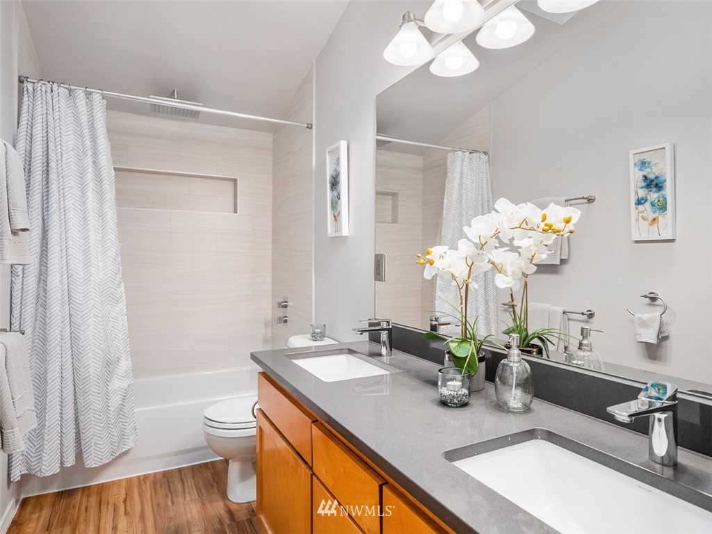 1212 North 85th Street, Unit B Seattle, WA 98103 - Photo 15 of 28 a bathroom with a sink a toilet and a bathtub