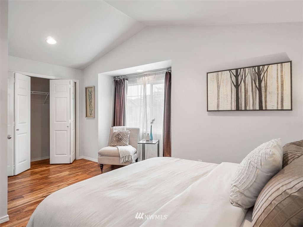 1212 North 85th Street, Unit B Seattle, WA 98103 - Photo 17 of 28 a bedroom with a bed and wooden floor