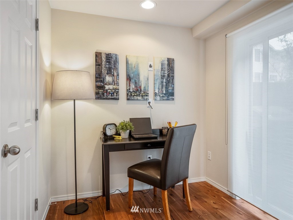 1212 North 85th Street, Unit B Seattle, WA 98103 - Photo 21 of 28 a view of a workspace with furniture and wooden floor