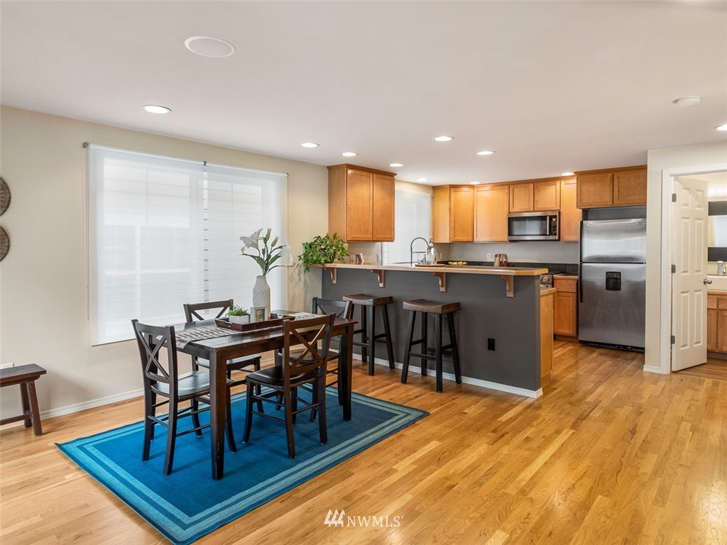 1212 North 85th Street, Unit B Seattle, WA 98103 - Photo 4 of 28 a view of a dining room with furniture and wooden floor