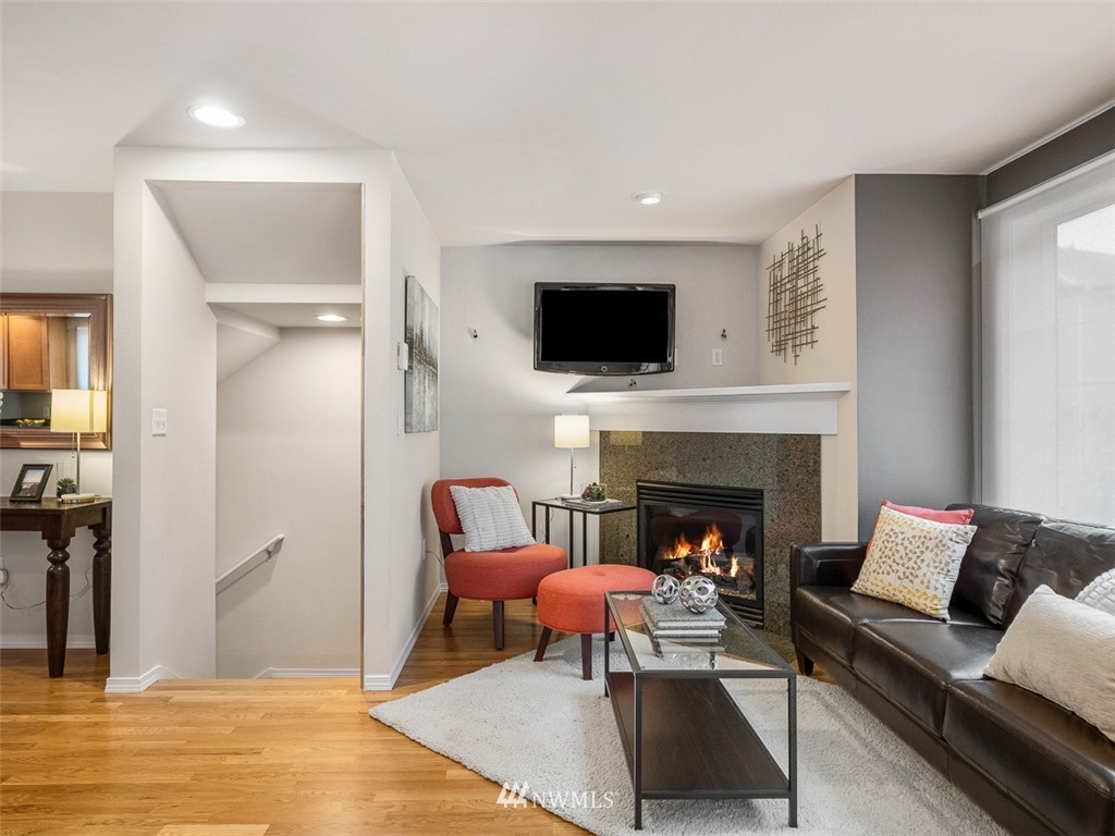 1212 North 85th Street, Unit B Seattle, WA 98103 - Photo 5 of 28 a living room with furniture a fireplace and a flat screen tv