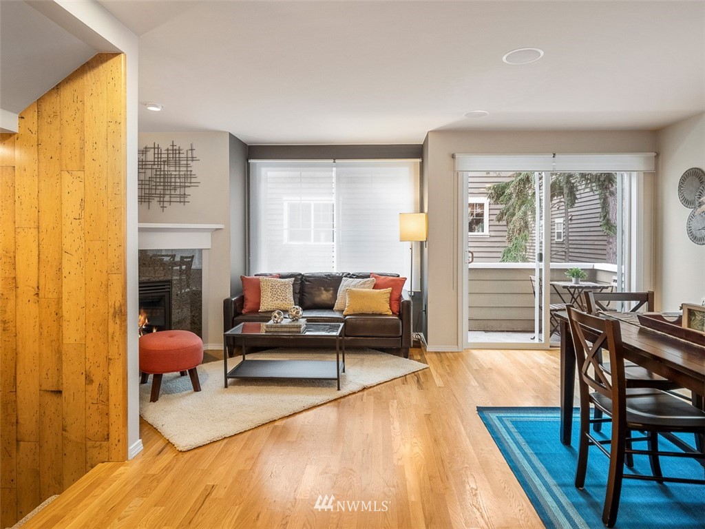 1212 North 85th Street, Unit B Seattle, WA 98103 - Photo 6 of 28 a living room with furniture a fireplace and wooden floor